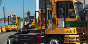 A row of yellow electric Hustler trucks.